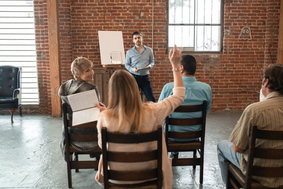 Informal meeting with diverse adults discussing topics in a brick-walled room.